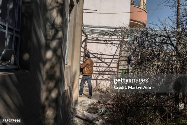 An Assyrian Christian man who fled Islamic State in August, 2014 from Qaraqosh, Iraq's largest Christian city, returns to his family home on February...