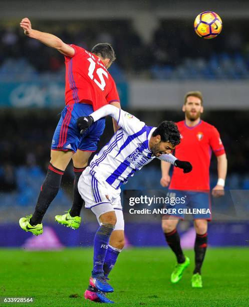 Osasuna's defender Unai Garcia vies with Real Sociedad's Mexican forward Carlos Vela during the Spanish league football match Real Sociedad vs CA...