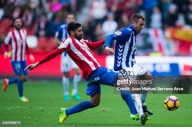 Nenad Krsticic of Deportivo Alaves duels for the ball with Carlos Carmona of Real Sporting de Gijon during the La Liga match between Real Sporting de...