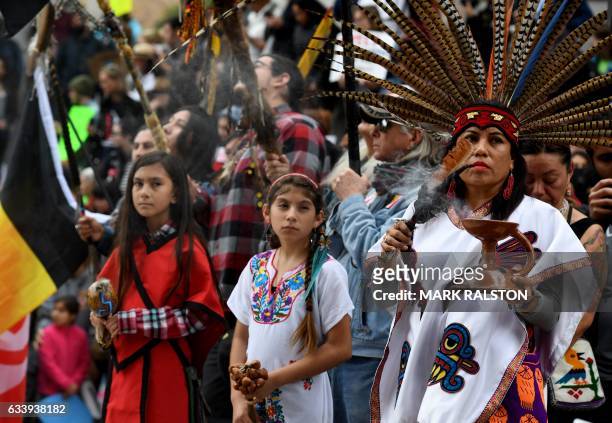 Native Americans lead demonstrators as they march to the Federal Building in protest against President Donald Trump's executive order fast-tracking...