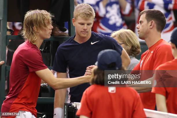 Denis Shapovalov of Canada shake hands with Great Britain coach Leon Smith and Kyle Edmund of Great Britain on the third day of Davis Cup first round...
