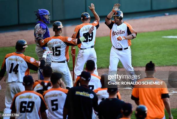 Rene Reyes of Aguilas del Zulia of Venezuela celebrates his home run against Tigres del Licey of the Dominican Republic during the Caribbean Baseball...