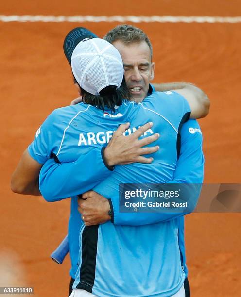 Carlos Berlocq of Argentina hugs to Daniel Orsanic captain of Argentina to celebrate after wining the singles match between Carlos Berlocq and Paolo...