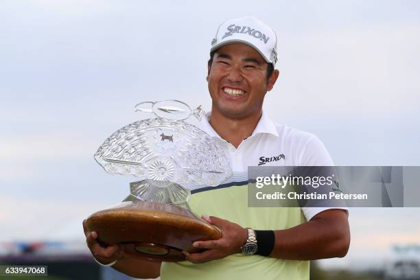 Hideki Matsuyama of Japan poses with the trophy after winning the Waste Management Phoenix Open on the fourth playoff hole at TPC Scottsdale on...
