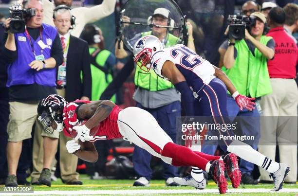 Julio Jones of the Atlanta Falcons makes a catch over Eric Rowe of the New England Patriots in the fourth quarter during Super Bowl 51 at NRG Stadium...