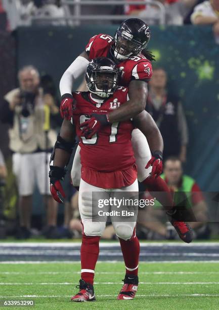 Grady Jarrett of the Atlanta Falcons celebrates with Jonathan Babineaux after sacking Tom Brady of the New England Patriots during the fourth quarter...