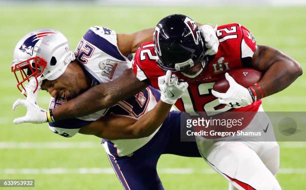 Mohamed Sanu of the Atlanta Falcons avoids a tackle by Logan Ryan of the New England Patriots in the fourth quarter during Super Bowl 51 at NRG...
