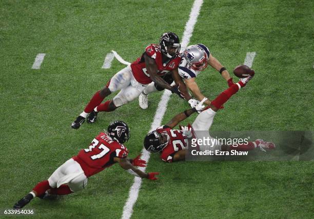 Julian Edelman of the New England Patriots makes a 23 yard catch in the fourth quarter against Ricardo Allen, Robert Alford and Keanu Neal of the...
