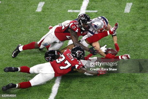 Julian Edelman of the New England Patriots makes a 23 yard catch in the fourth quarter against Ricardo Allen, Robert Alford and Keanu Neal of the...