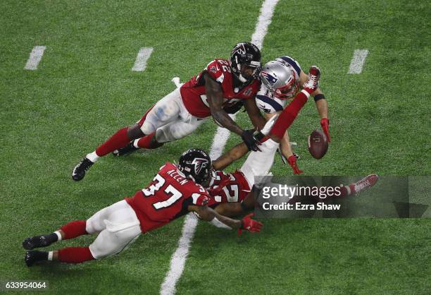 Julian Edelman of the New England Patriots makes a 23 yard catch in the fourth quarter against Ricardo Allen, Robert Alford and Keanu Neal of the...