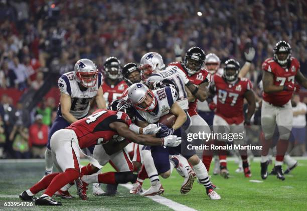 Danny Amendola of the New England Patriots scores a two point conversion late in the fourth quarter against Jalen Collins and Brian Poole of the...