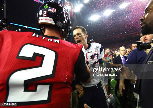 Tom Brady of the New England Patriots speaks to Matt Ryan of the Atlanta Falcons after winning Super Bowl 51 at NRG Stadium on February 5, 2017 in...