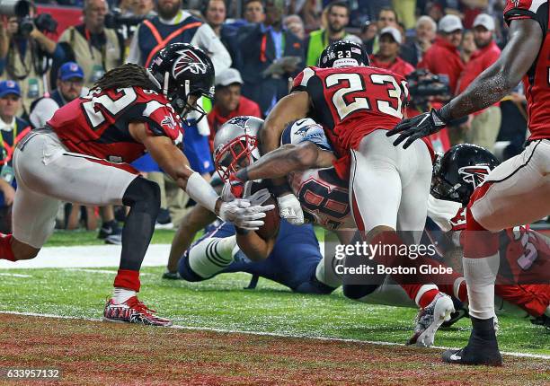 New England Patriots running back James White lunges for the end zone as he scores the game winning touchdown in overtime. The Atlanta Falcons play...