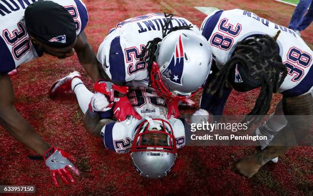 James White of the New England Patriots celebrates with teammates after defeating the Atlanta Falcons 34-28 in overtime to win Super Bowl 51 at NRG...