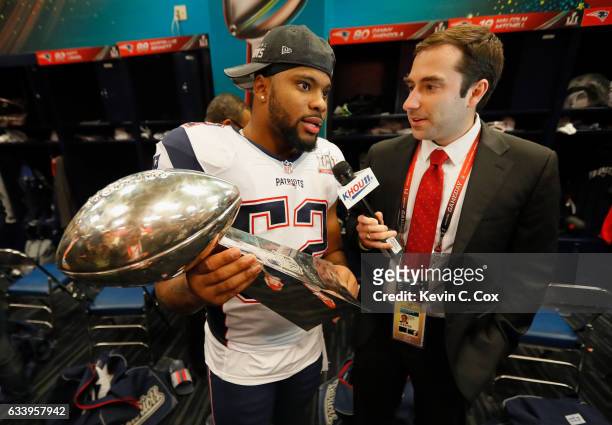Elandon Roberts of the New England Patriots celebrates in the locker room with the Vince Lombardi trophy after defeating the Atlanta Falcons during...
