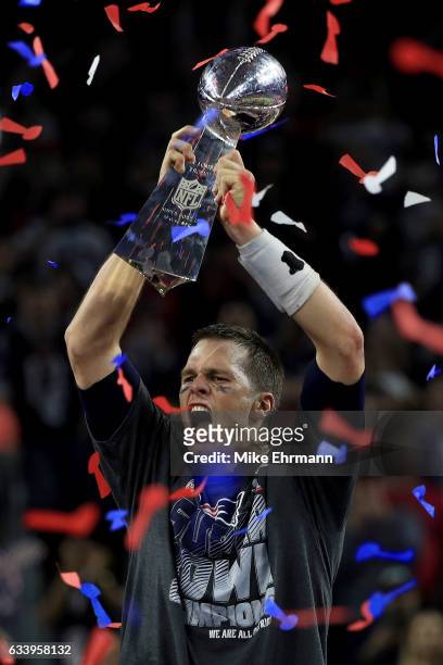 Tom Brady of the New England Patriots celebrates with the Vince Lombardi Trophy after defeating the Atlanta Falcons 34-28 in overtime during Super...