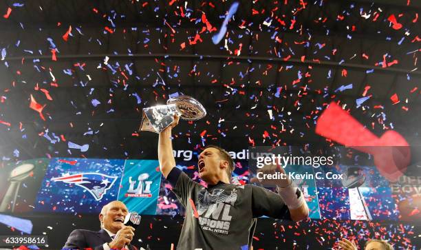 Tom Brady of the New England Patriots raises the Vince Lombardi Trophy after defeating the Atlanta Falcons during Super Bowl 51 at NRG Stadium on...