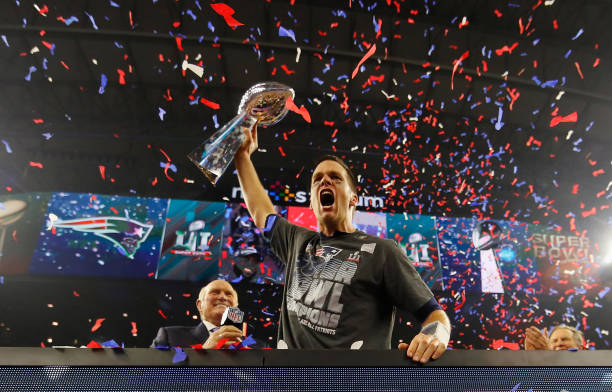 Tom Brady of the New England Patriots raises the Vince Lombardi Trophy after defeating the Atlanta Falcons during Super Bowl 51 at NRG Stadium on...