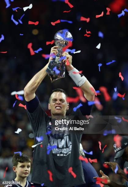 Tom Brady of the New England Patriots raises the Vince Lombardi trophy after the Patriots defeat the Atlanta Falcons in overtime of Super Bowl 51 at...