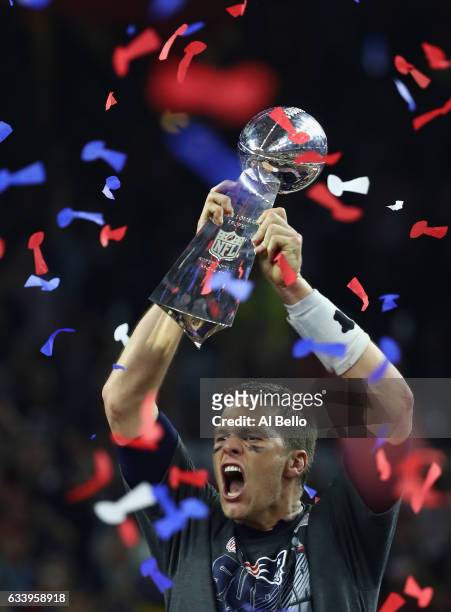 Tom Brady of the New England Patriots raises the Vince Lombardi trophy after the Patriots defeat the Atlanta Falcons in overtime of Super Bowl 51 at...