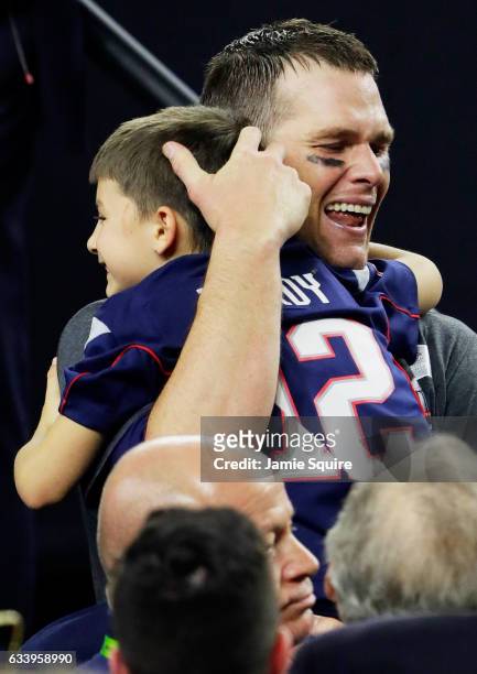 Tom Brady of the New England Patriots celebrates with his son after defeating the Atlanta Falcons 34-28 in overtime to win Super Bowl 51 at NRG...