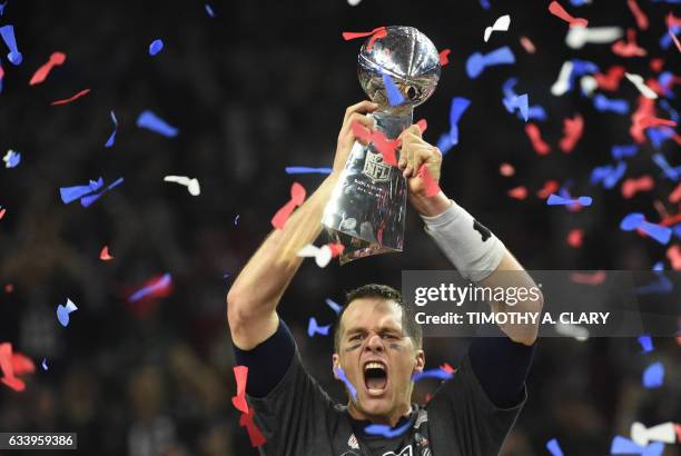 Tom Brady of the New England Patriots holds the Vince Lombardi Trophy after defeating the Atlanta Falcons 34-28 in overtime during Super Bowl 51 at...