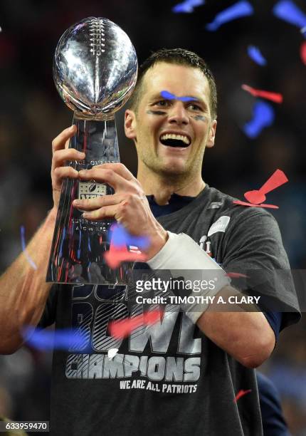 Tom Brady of the New England Patriots holds the Vince Lombardi Trophy after defeating the Atlanta Falcons 34-28 in overtime during Super Bowl 51 at...