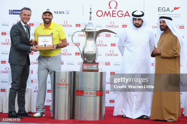 Sergio Garcia of Spain is presented with his winners Omega watch by Raynald Aeschlimann the CEO of Omega as His Highness Shaikh Ahmed Bin Mohammed...