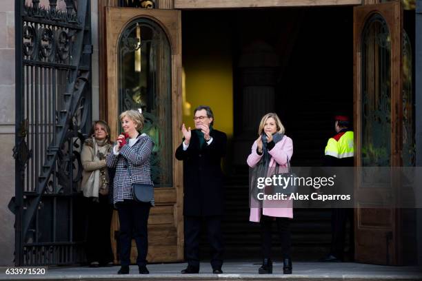 Former Education Minister Irene Rigau, former Catalan President Artur Mas and former Vice-president Joana Ortega applaud to the crowd as they arrive...