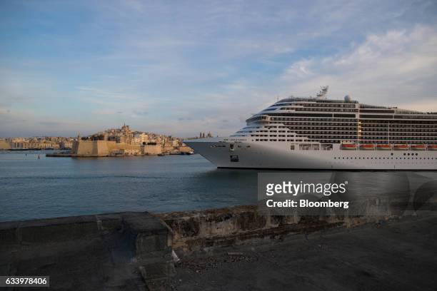 The MSC Splendida cruise ship, operated by Mediterranean Shipping Co., sails past St. Phillip's Church as it stands on the Mediterranean waterfront...