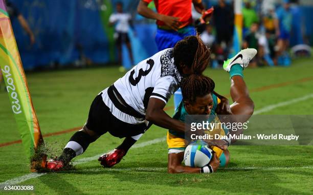 Ellia Green of Australia dives over for a try as she is tackled by Raijieli Daveua of Fiji during the Women's Rugby Sevens Pool A match between...