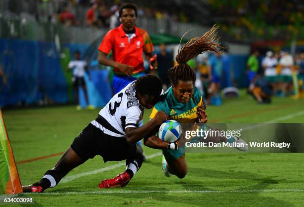 Ellia Green of Australia dives over for a try as she is tackled by Raijieli Daveua of Fiji during the Women's Rugby Sevens Pool A match between...