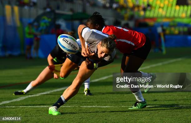 Caroline Ladagnous of France fumbles the ball over the line as she is tackled by Janet Okelo of Kenya during the Women's Rugby Sevens Pool B match...