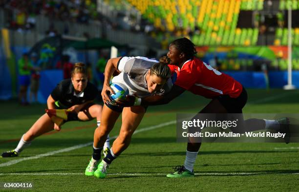 Caroline Ladagnous of France fumbles the ball over the line as she is tackled by Janet Okelo of Kenya during the Women's Rugby Sevens Pool B match...