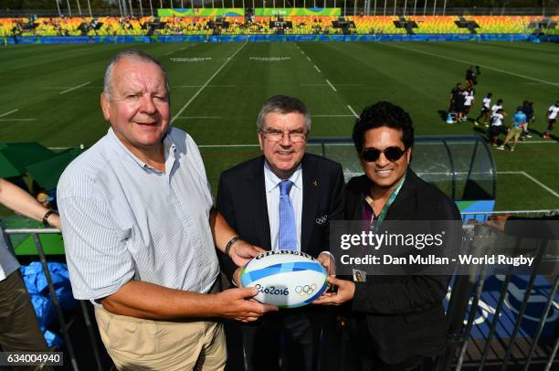 Thomas Bach, President of the International Olympic Committee is presented with a match ball by Bill Beaumont, Chairman of World Rugby via Getty...