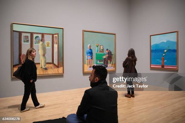 Visitors view 'Looking At Pictures On A Screen', 1977; My Parents' and 'Mount Fuji and Flowers', 1972 by David Hockney during a press preview for the...