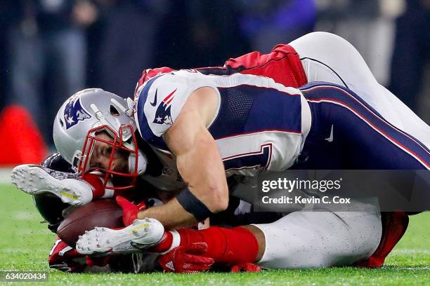 Julian Edelman of the New England Patriots makes a 23 yard catch in the fourth quarter against Ricardo Allen and Keanu Neal of the Atlanta Falcons...