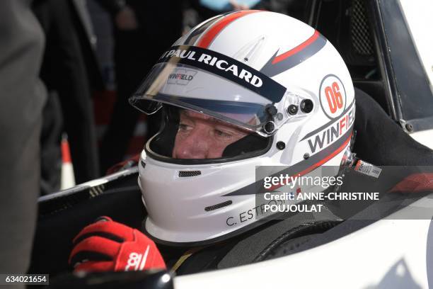 Provence-Alpes-Cote d'Azur regional council president Christian Estrosi dressed in a racing suit sits in a single-seater car during a meeting...