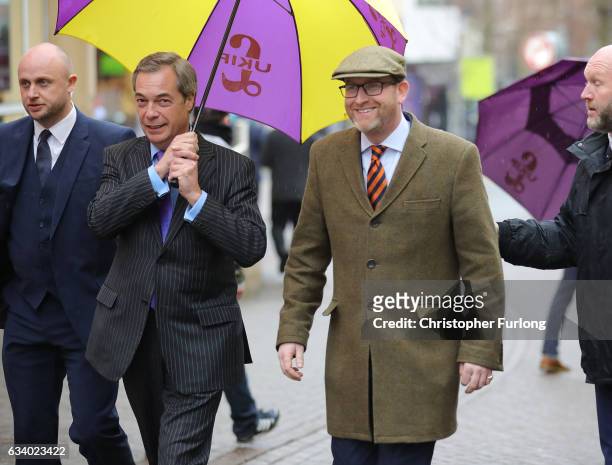 Leader Paul Nuttall and former Leader Nigel Farage MEP laugh off an egg thrown by a youth as they arrive in Stoke-On-Trent for a public meeting this...