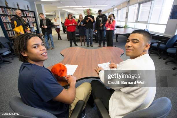 Friends and family take pictures as Clarkson Secondary School students Tyrell Richards and Deionte Knight sign to play football at colleges in the...