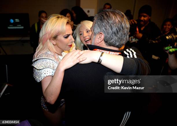 Musician Lady Gaga hugs her parents Cynthia Germanotta and Joe Germanotta backstage after the Pepsi Zero Sugar Super Bowl LI Halftime Show at NRG...