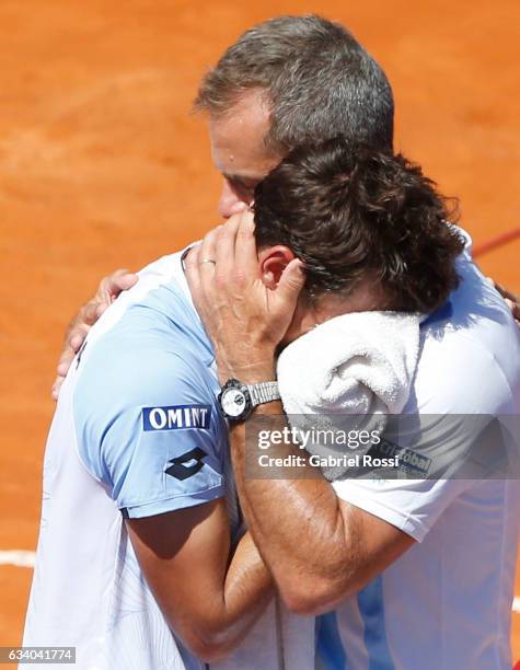 Guido Pella of Argentina looks dejected as Daniel Orsanic captain of Argentina cheers him up during a singles match between Guido Pella and Fabio...