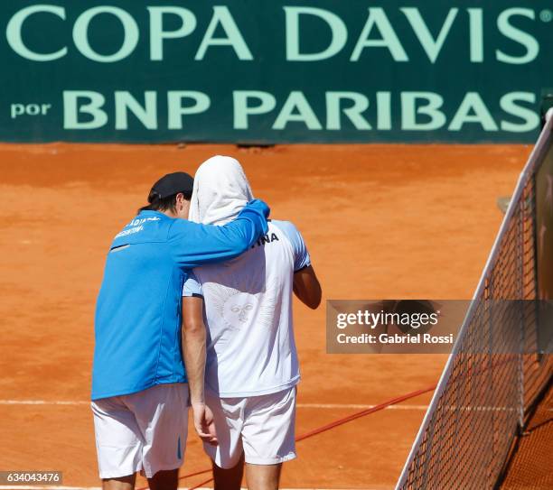 Guido Pella of Argentina leaves the field with Carlos Berlocq of Argentina after losing a singles match as part of day 3 of the Davis Cup 1st round...