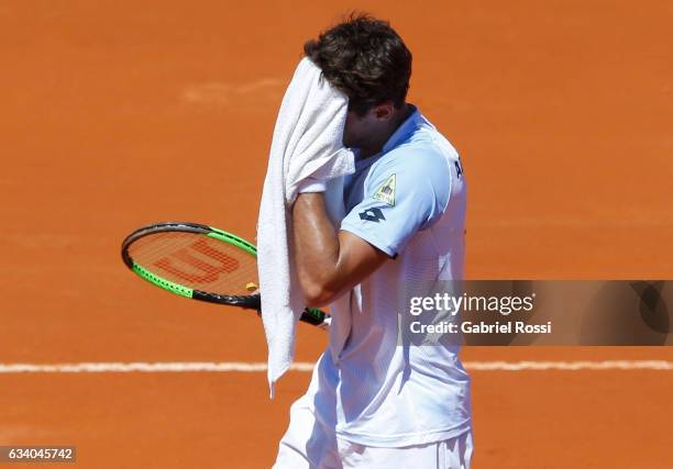 Guido Pella of Argentina dries hisface during a singles match as part of day 3 of the Davis Cup 1st round match between Argentina and Italy at Parque...