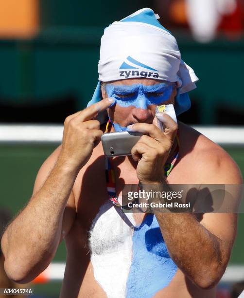 Fan of Argentina paints his face during a singles match between Guido Pella and Fabio Fognini as part of day 3 of the Davis Cup 1st round match...