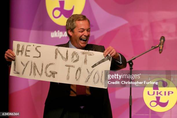 Former UKIP Leader, Nigel Farage MEP holds a sign during a public meeting on February 6, 2017 in Stoke, England. The Stoke-on-Trent central...