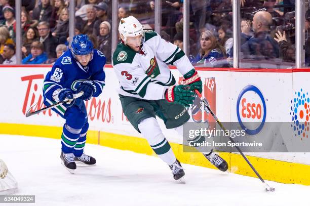 Minnesota Wild Right Wing Charlie Coyle is pursued by Vancouver Canucks Defenceman Philip Larsen during their NHL game at Rogers Arena on February 4,...