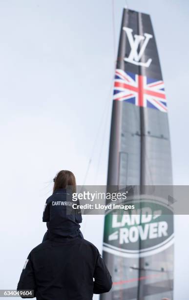 Crowds and family of the team watch the wing being lifted prior to the launch of the teams new Land Rover BAR R1 race yacht 'RITA' on February 6,...