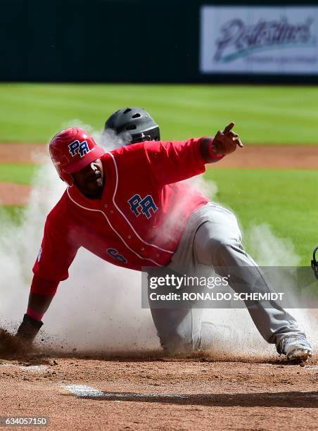 Ruben Gotay of Criollos de Caguas of Puerto Rico slides safe in home during a Caribbean Baseball Series match against Aguilas del Zulia of Venezuela...