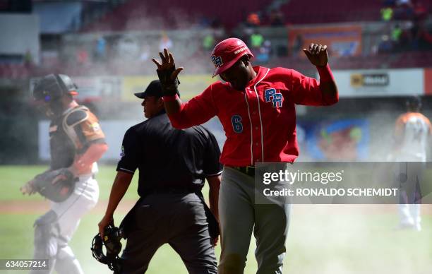 Ruben Gotay of Criollos de Caguas of Puerto Rico celebrates after scoring during a Caribbean Baseball Series match against Aguilas del Zulia of...